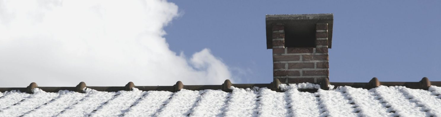 Workers on roof builder checking chimney taking notes