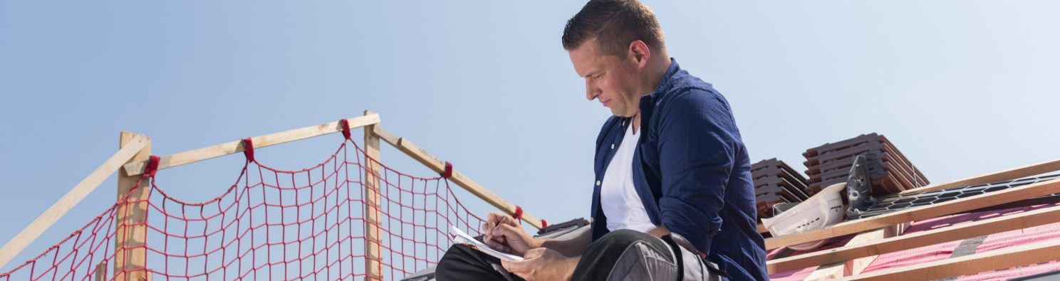 Roofer sitting on timber batten