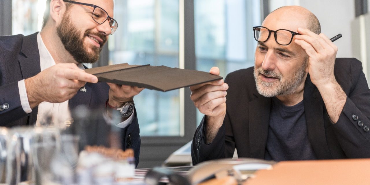 Architect inspecting clay roof or facade tile (Bellus, Facatile) at a meeting room with Wienerberger employee, Fast Forward Commercial Excellence