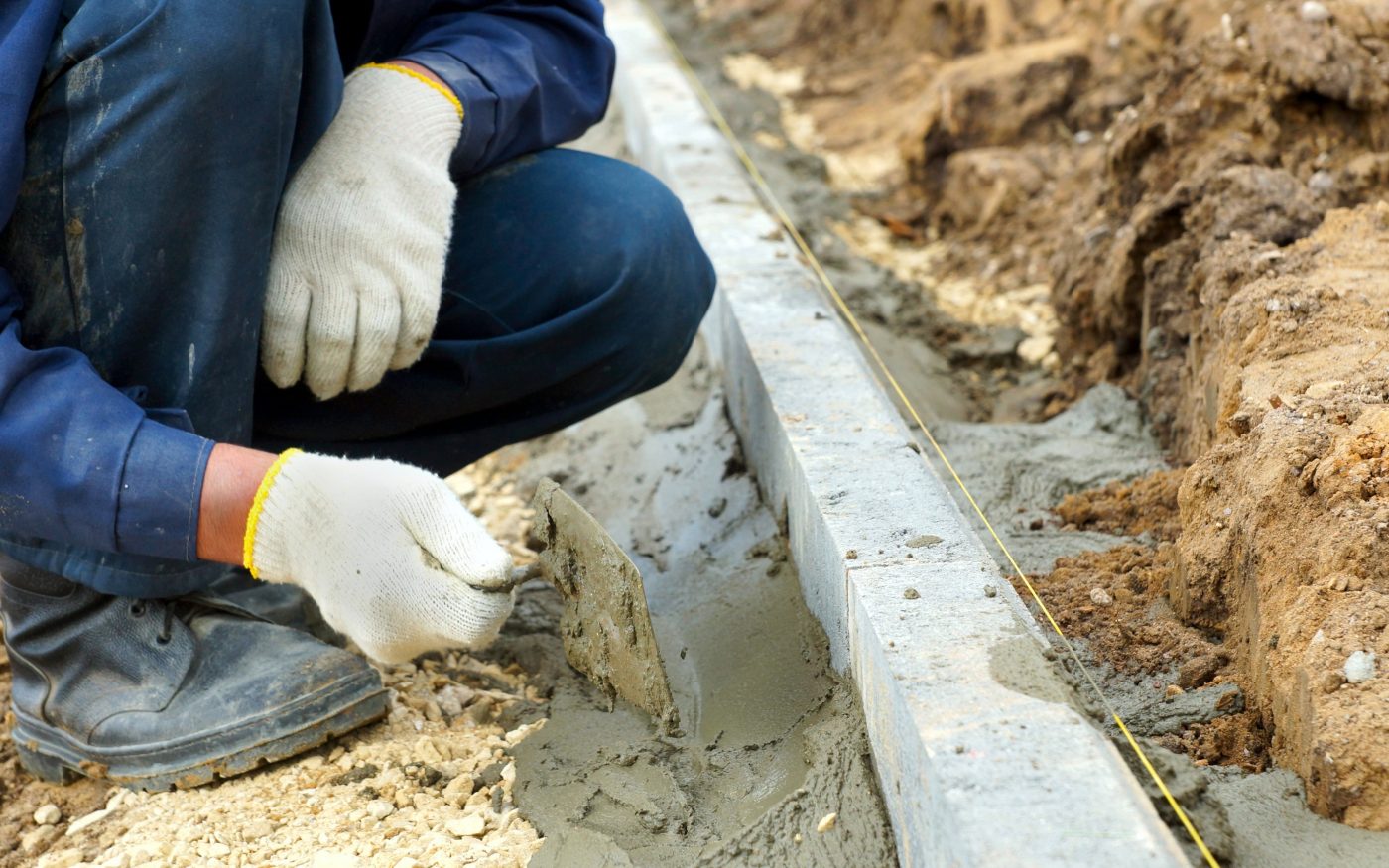 Worker placed curbs, close-up photos.