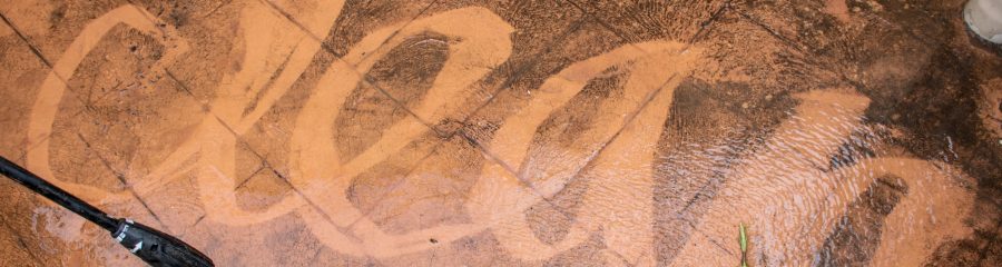 Cleaning backyard paving tiles with high pressure washer. Spring clean up