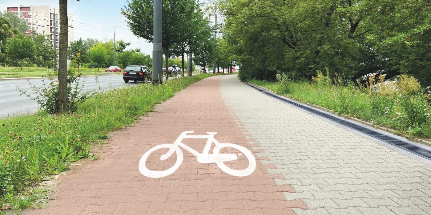 Street with road, pedestrian zone and red paved bicycle lane