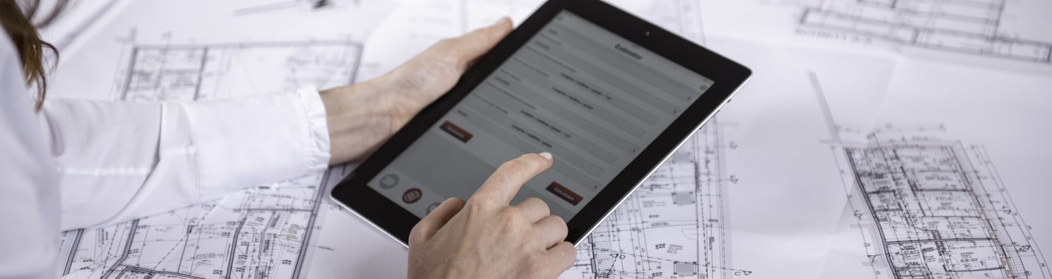 Woman at workplace with blueprint holding tablet computer, Fast Forward Commercial Excellence
